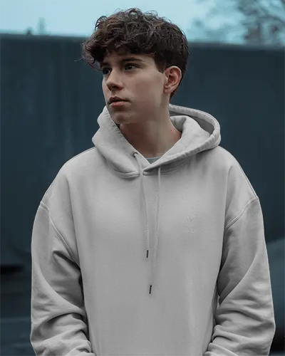Overcast Outdoor Hoodie Mockup Teen Male Model Wearing White Hoodie In Moody Blue Background Natural Light 0710
