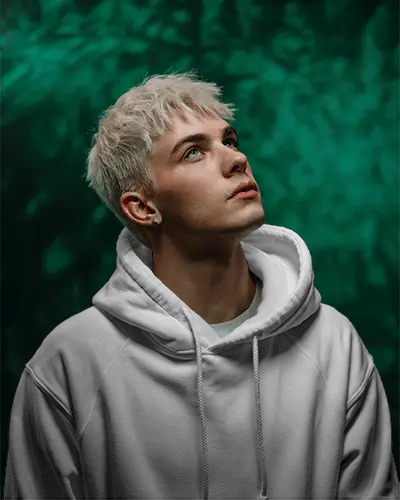 Fashion Forward Hoodie Template With Model Gazing Up Into Light