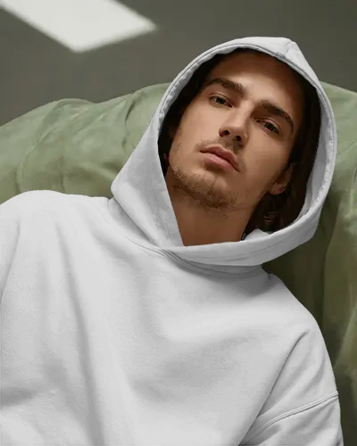 Casual Hoodie Mockup Young Man Wearing Hooded Hoodie In Laid Pose Modern Studio Setting