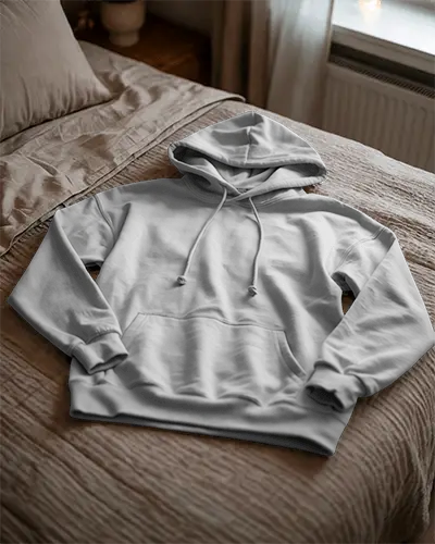 Cozy Bedroom Hoodie Mockup Folded White Hoodie Resting On Beige Bedspread In Sunlit Interior 0790