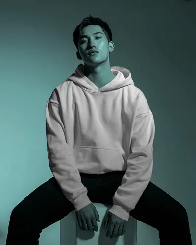 Studio Hoodie Mockup Male Model Sitting In Moody Teal Light With Shadowed Urban Styling