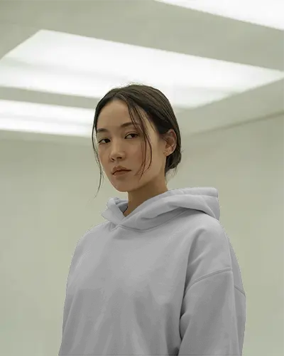 Minimalist Studio Hoodie Mockup Female Model In Hoodie Under Soft Panel Lighting