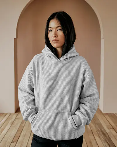 minimal-arched-room-hoodie-mockup-texture-fabric-woman-posing-with-hands-in-pocket