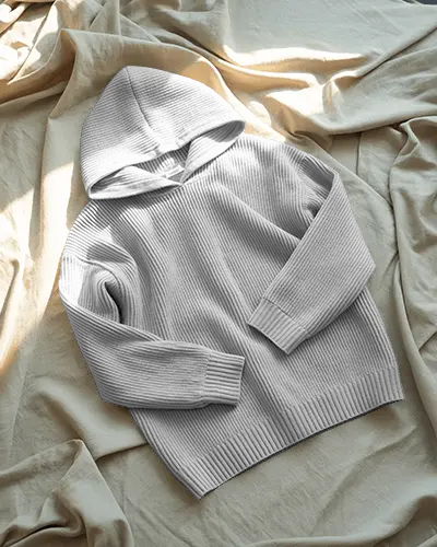 cozy-soft-light-flatlay-hoodie-mockup-knit-hoodie-on-wrinkled-bed-sheet