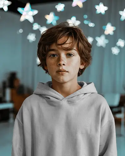 Dreamy Indoor Hoodie Mockup Young Boy With Freckles Under Glowing Star Decor Backdrop Soft Focus