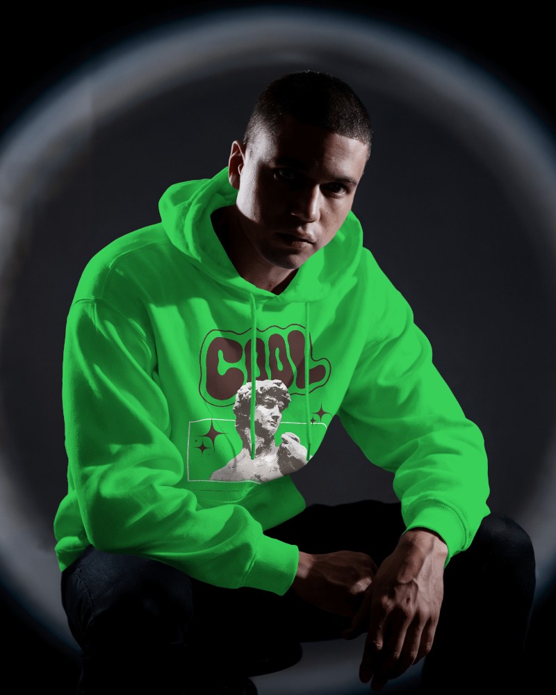 Full Body Pose Showcasing Confidence With Hands In Pockets Highlighting The Sleek Silhouette Of The Hoodie Mockup Against A Shadowy Backdrop