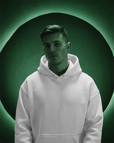 Hoodie Mockup On Male Model With Green Backdrop Dramatic And Modern Vibe