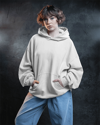 Moody Studio Hoodie Mockup Female Model Hands In Pocket Dark Backdrop