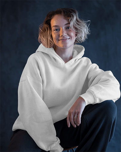 Soft Lit Hoodie Mockup Female Model Smiling With Relaxed Posture Against Neutral Background