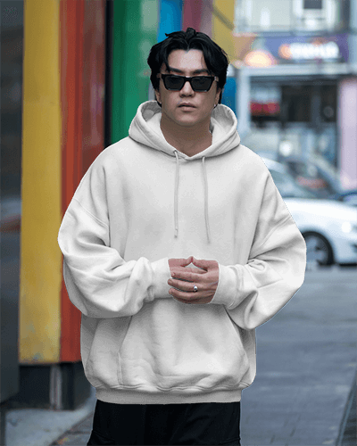 Bold White Hoodie Mockup Male Model Serious Pose In A Busy Street Setting Edgy Style