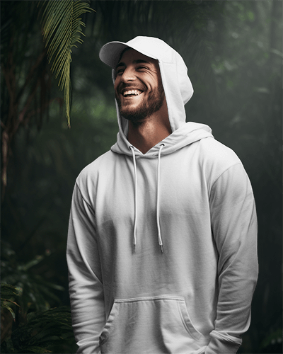 Male Model Smiling In Hoodie Mockup With Tropical Forest Surrounding