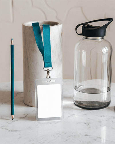 Id Card Mockup Transparent Holder With Blue Lanyard On Marble Surface Alongside Pencil Vase And Water Bottle Modern And Minimalist Setup 020