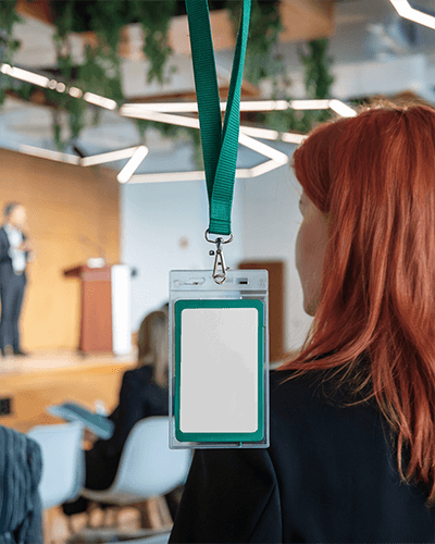 Id Card Mockup Conference Event Green Lanyard Red Haired Attendee Modern Lit Venue Professional Networking Setting 068