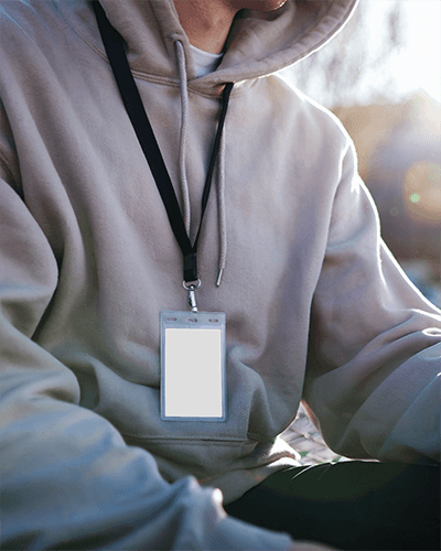 Outdoor Casual Id Card Mockup On Seated Man Wearing Beige Hoodie In Natural Sunlight Relaxed Atmosphere 079