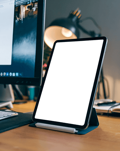 Modern Desk Setup Ipad Mockup On Wooden Table With Desktop Monitor And Warm Desk Lamp Productive And Cozy Workspace