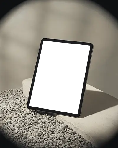 Ipad Pro Mockup On Pebble Surface Leaning Against Minimal Concrete Block