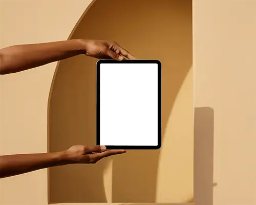 Vertical Ipad Mini Mockup Held With Two Hands On Beige Architectural Setting