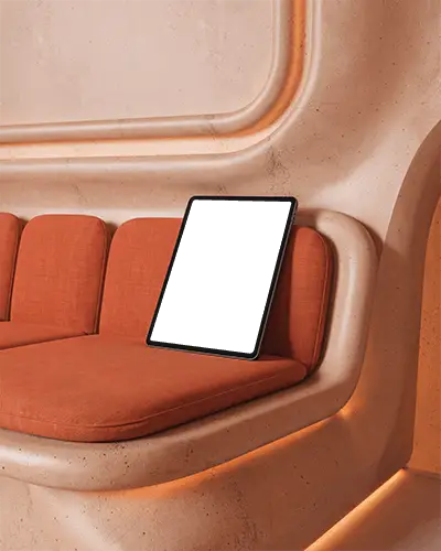 Ipad Pro Mockup Resting On Curved Sofa With Orange Cushions In Modern Architectural Lounge