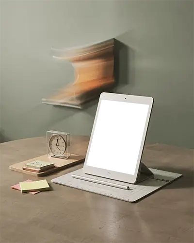 Angled Ipad Mini Mockup In Stand Position On Matte Desk With Stationery And Speed Blur