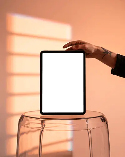 Warm Sunset Ipad Pro Mockup Held Over Glass Stool With Shadow Lines And Minimal Style