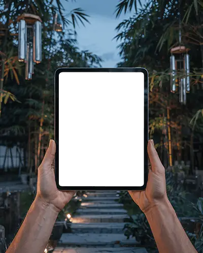 outdoor-ipad-air-mockup-with-hands-raised-in-serene-evening-bamboo-walkway-scene