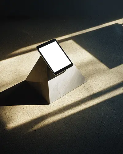 minimalist-ipad-mini-mockup-on-stone-pyramid-stand-in-sunlit-modern-interior-with-soft-lighting