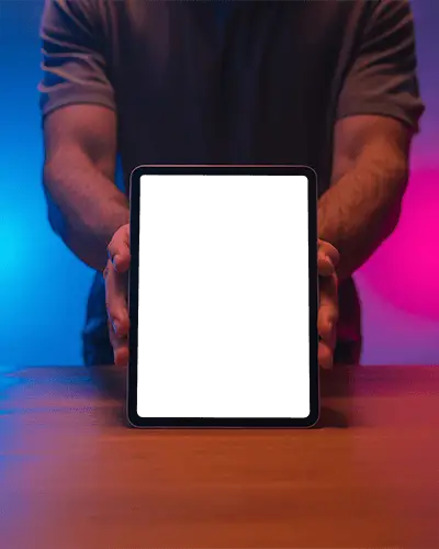 Ipad Mini Mockup Hand Held Upright On Wooden Table With Blue And Pink Neon Lighting
