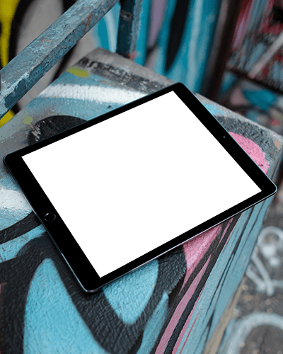Urban Ipad Mockup Digital Tablet On Graffiti Covered Surface Showcasing Celestial Artwork Neon Moon And Stars Street Style Aesthetic