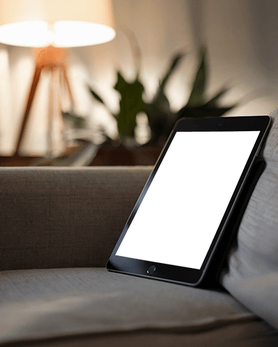 Cozy Living Room Ipad Mockup Digital Tablet Resting On Couch With Warm Lamp Lighting And Soft Home Ambience Relaxed Evening Vibes