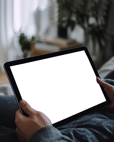 Comfortable Lifestyle Ipad Mockup Hands Holding Digital Tablet In Relaxed Home Setting With Blurred Background