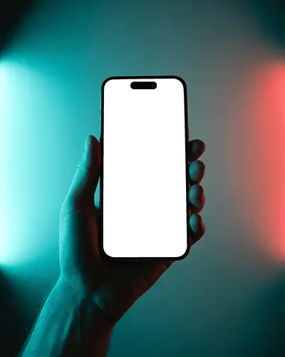 Hand Holding Iphone 14 Pro Mockup With Red And Blue Neon Glow Background Modern Studio Light