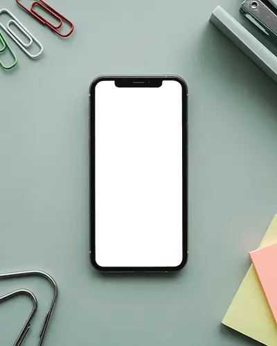 Top View Iphone 12 Mockup On Pastel Desk With Stationery Items And Paper Clips