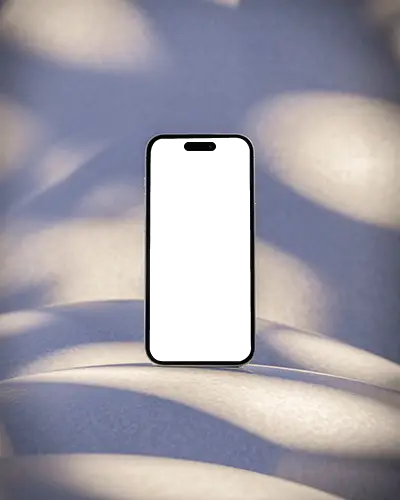 iphone-15-plus-mockup-on-curved-surface-with-dappled-light-shadow-in-soft-abstract-scenery