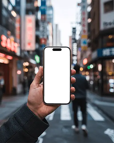 iphone-16-mockup-hand-holding-smartphone-in-busy-urban-street-with-neon-signs