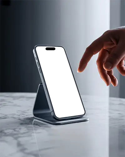 Iphone 16 Mockup On Stand With Hand Reaching Over Marble Table In Modern Lighting