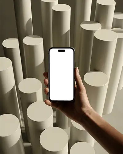 Artistic Cylinder Background Iphone 16 Pro Mockup Hand Holding Phone In Soft Warm Light