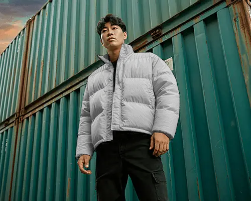 Industrial Yard Puffer Jacket Mockup Strong Stance Against Weathered Containers