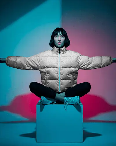 Cinematic Puffer Jacket Mockup Female Model Arms Outstretched Bold Studio Lighting
