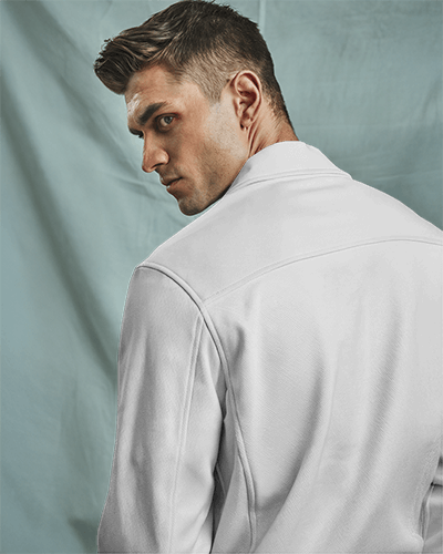 studio-lighting-jacket-mockup-back-view-male-model-turning-head-showing-white-zip-up-jacket-against-soft-blue-fabric-backdrop-modern-and-sleek-design-031