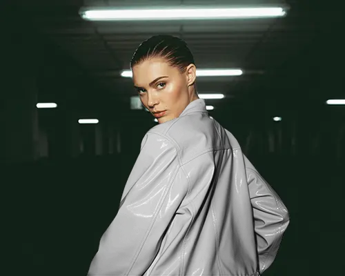 Glossy Leather Jacket Mockup Female Model Turning Back Under Fluorescent Lights Minimal Vibe