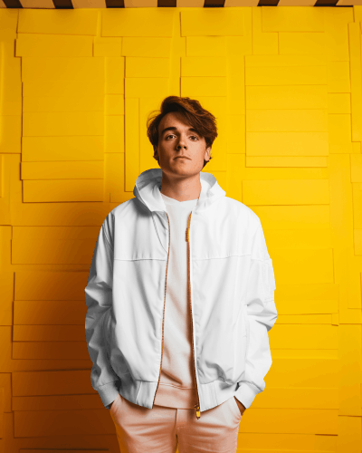 person-wearing-varsity-jacket-standing-in-front-of-yellow-screen