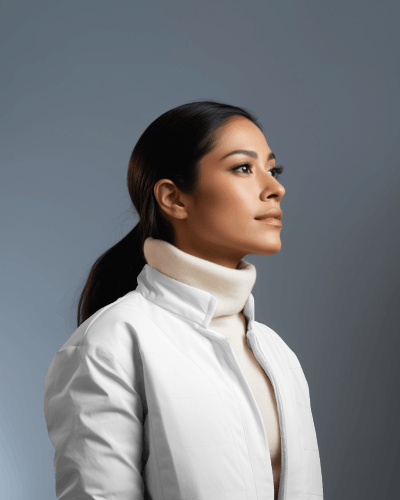 side-view-of-a-hispanic-woman-wearing-a-warm-jacket-in-front-of-white-screen