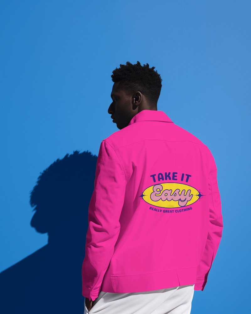 A Person Wearing Varsity Jacket Standing In Front Of Blue Screen