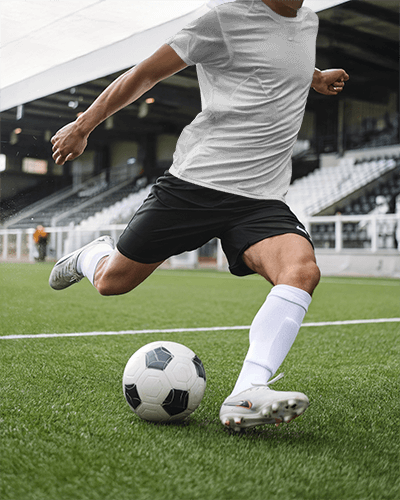 Dynamic Football Jersey Mockup Male Athlete In Action On Grassy Field Under Bright Stadium Lights