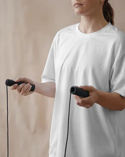 stylish-athletic-jersey-mockup-on-woman-in-training-mood-holding-rope-with-focus-on-logo-zone