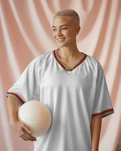 athletic-female-model-in-customizable-white-mesh-jersey-with-color-pop-details-holding-soccer-ball-ready-for-brand-logo-placement