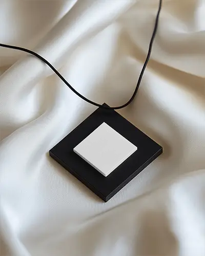 square-pendant-necklace-mockup-on-cream-satin-modern-black-rope-bold-contrast-styled-showcase