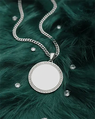 round-silver-pendant-mockup-arranged-green-fur-background-with-scattered-gems-and-glamorous
