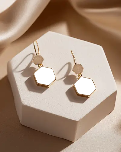 Modern Golden Hexagonal Pendant Earrings With Black Inserts On White Display