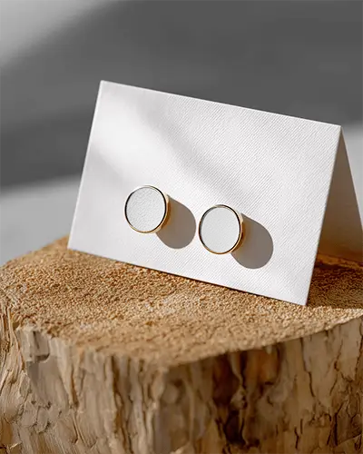 minimalistic-round-stud-earrings-mockup-on-textured-white-card-for-jewelry-display-and-marketing